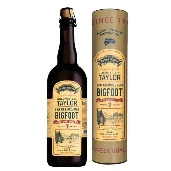 A bottle of E.H. Taylor Barrel-Aged Big Foot Bourbon with a glass beside it, showcasing the deep amber color and rich, complex flavors of this barrel-aged ale turned bourbon.