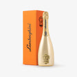 Gold champagne bottle with Lamborghini branding next to an orange box on a white background