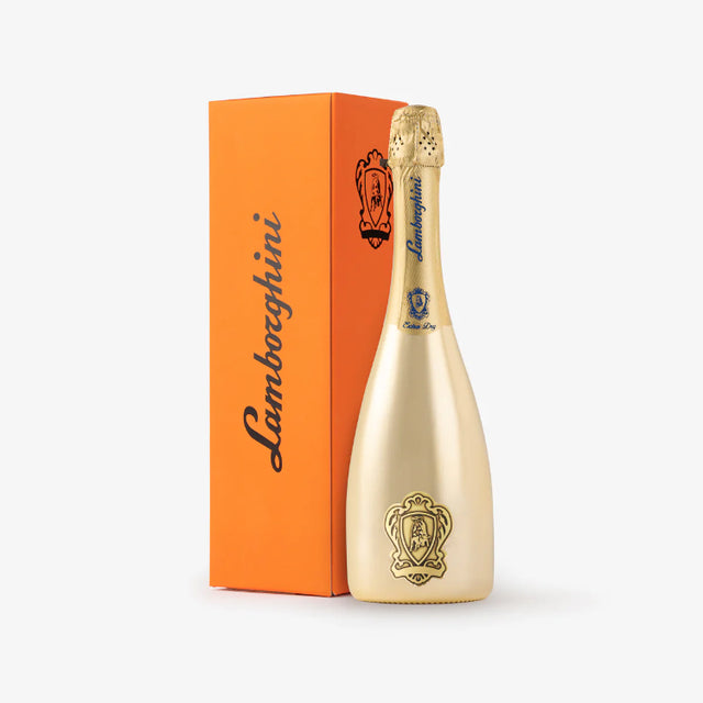 Gold champagne bottle with Lamborghini branding next to an orange box on a white background