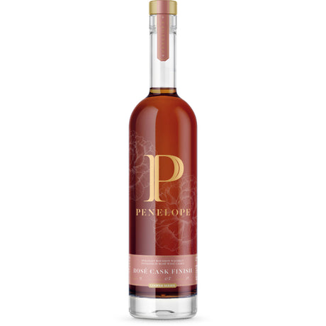 Bottle of Penelope whiskey with a red label on a white background